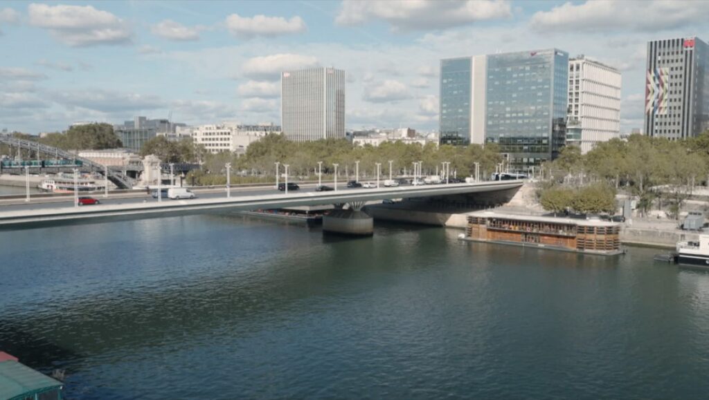 Paris cityscape with Seine River, bridge, and modern buildings. Architecture and urban landscape.