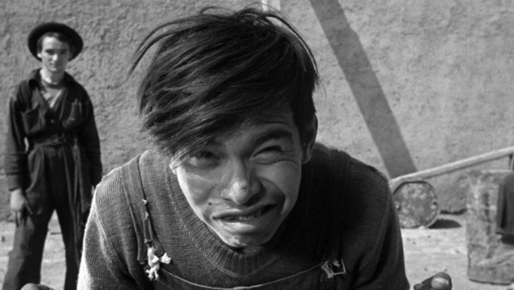 Los olvidados — Luis Buñuel Black and white film still of a young boy from Los Olvidados (1950). Mexican cinema.