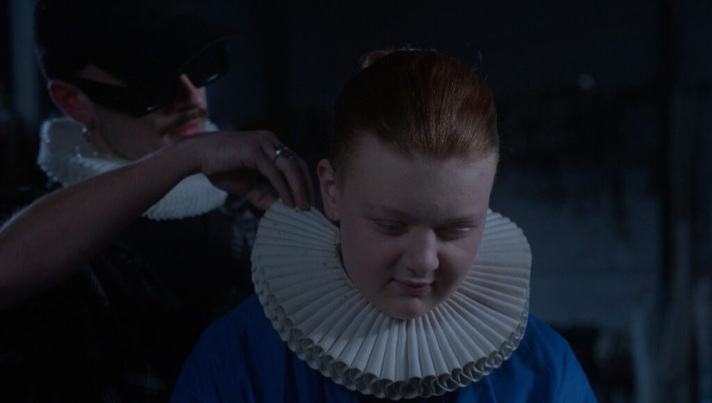 Still from Orlando, My Political Biography at San Sebastián Film Festival. Person adjusts ruff collar.