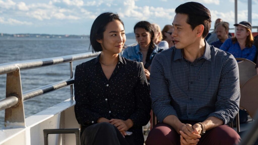 Greta Lee and Teo Yoo in Past Lives at San Sebastián Film Festival 2023. Candid shot on a boat.