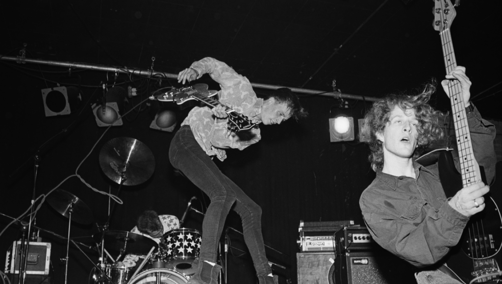 Florent Gouëlou's band, Three Nights a Week, live in concert. Black and white photo of musicians playing guitars and drums.