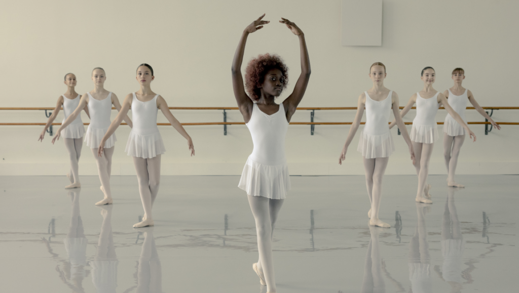 Three Nights a Week film still. Ballerinas in white dresses practice ballet. Dance studio with barre. Gaumont film.