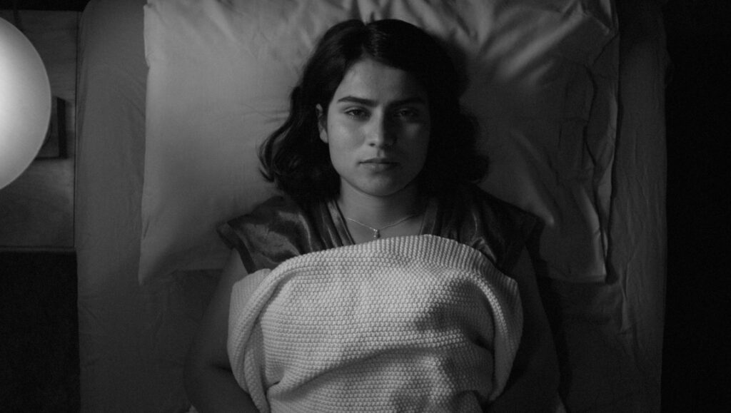 Laura Valladao in Fremont movie. Black and white portrait of actress in bed. Babak Jalali film.