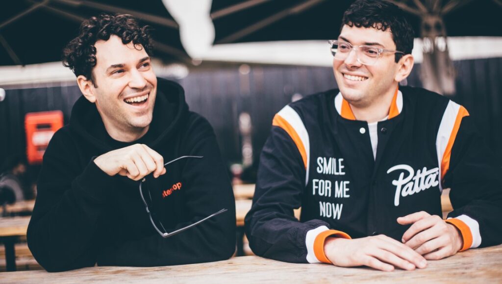 The Blog Era: Haunted Halls of the Internet Archive ItsTheReal, hip hop duo, Courtney and Eric, smiling. Eric wears a Patta jacket. Courtney wears a black hoodie.