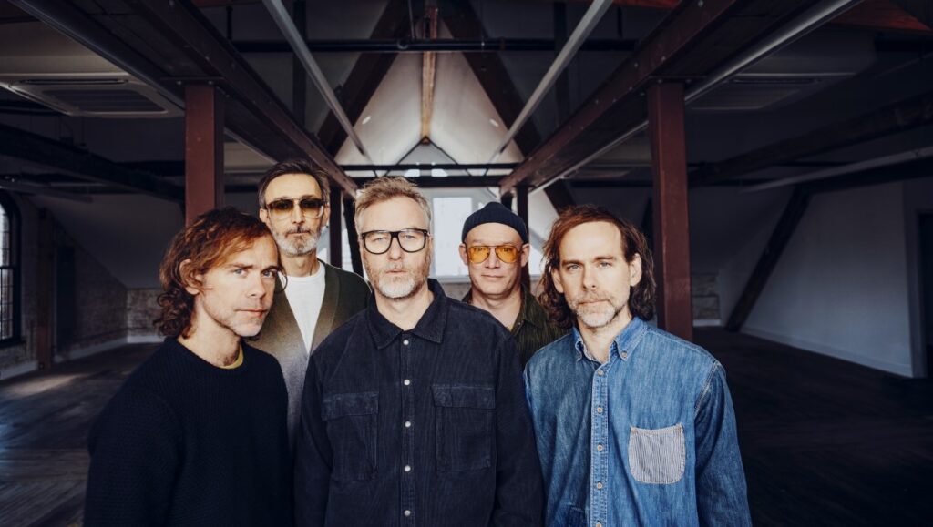 The National band portrait. Group shot of band members in industrial space.