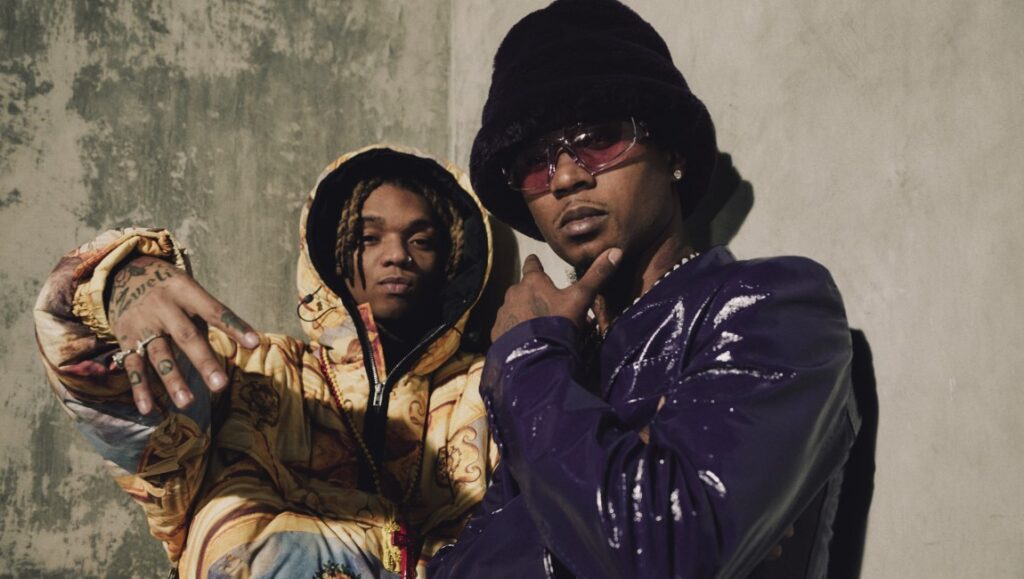 Rae Sremmurd promo shot. Swae Lee and Slim Jxmmi pose in stylish outfits. Hip-hop duo.