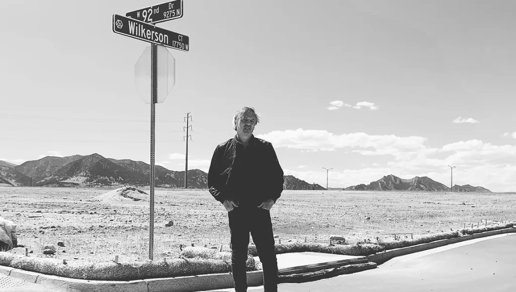 Black and white portrait of Travis Wilkerson at the crossroads. Wilkerson interview.