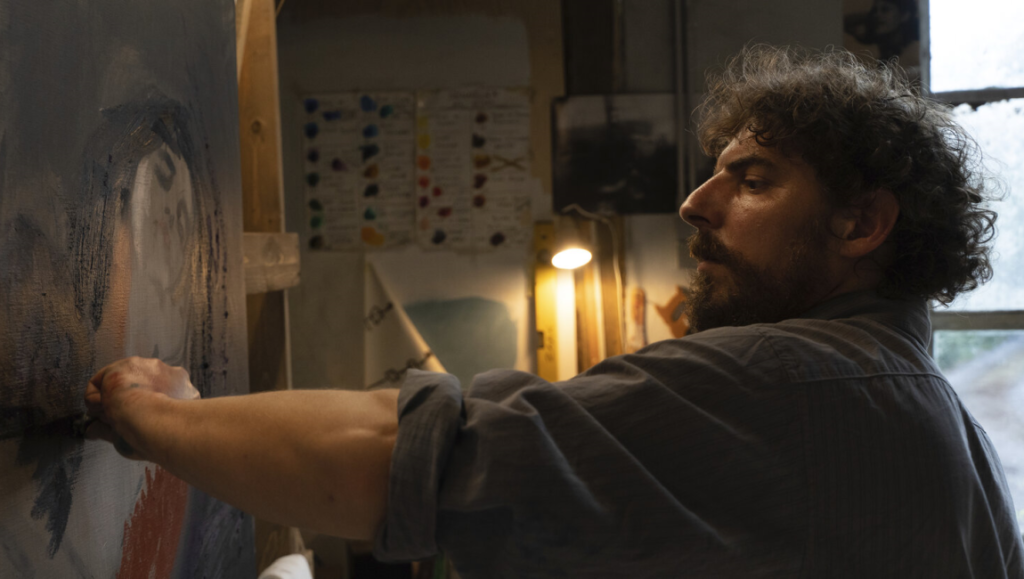 Artist painting on canvas. Man with beard in art studio creating artwork. Fine art concept.