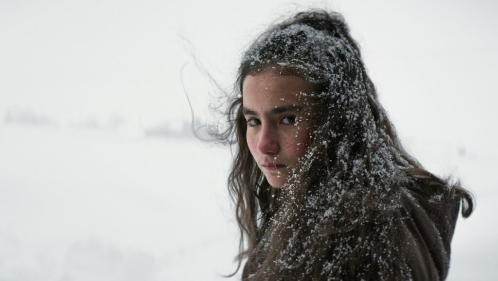 About Dry Grasses film review: Young woman covered in snow. Nuri Bilge Ceylan movie scene.