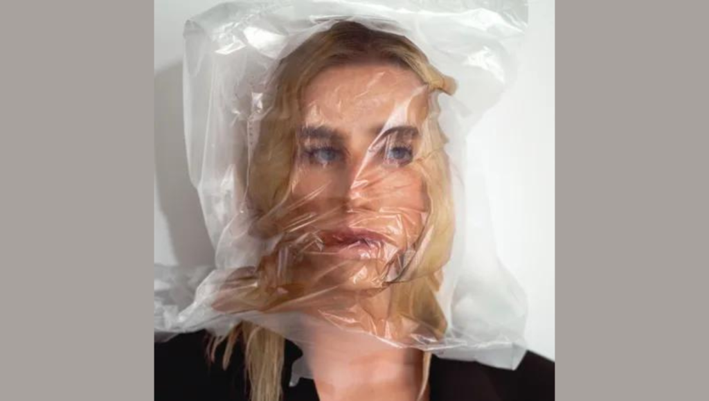 Kesha Gag Order album cover. Blonde woman with a plastic bag over her head. Conceptual art. Music.