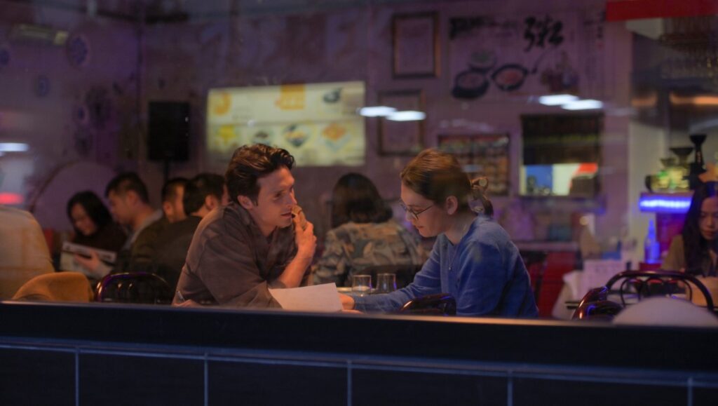Marguerite's Theorem movie scene. Anna Novion film review. Two people talking in a restaurant.