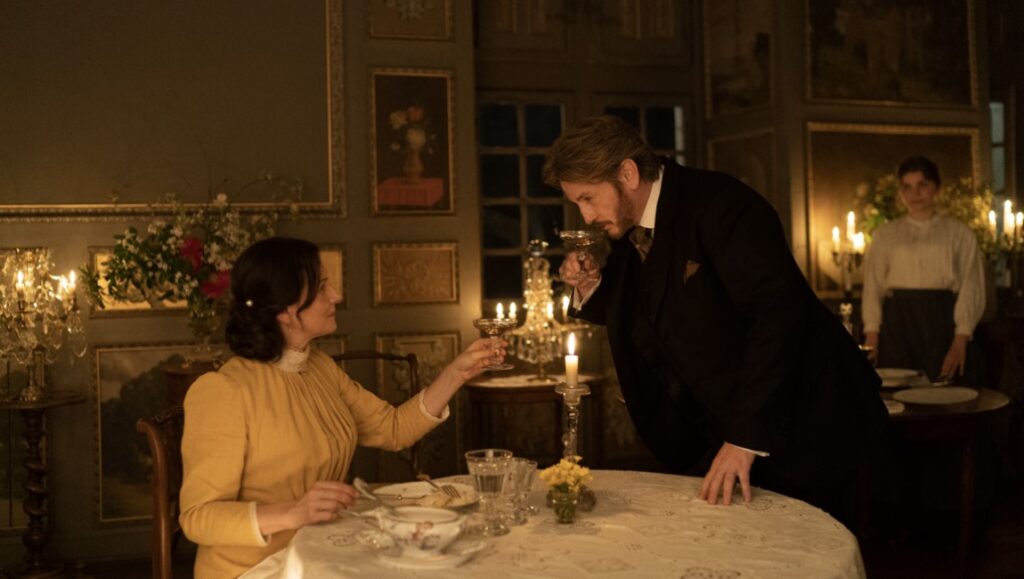 The Pot-au-Feu film scene: A couple toasting at dinner. French cuisine, period drama.