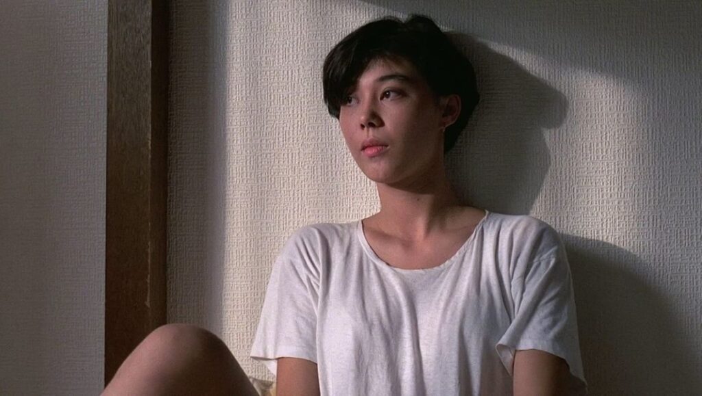 Still from Edward Yang's The Terrorizers featuring a young woman in a white t-shirt.