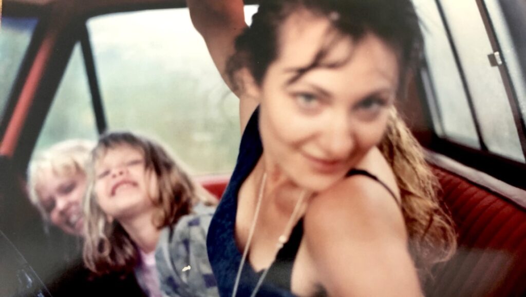 Anonymous Sister by Jamie Boyle: Three smiling sisters in a car.