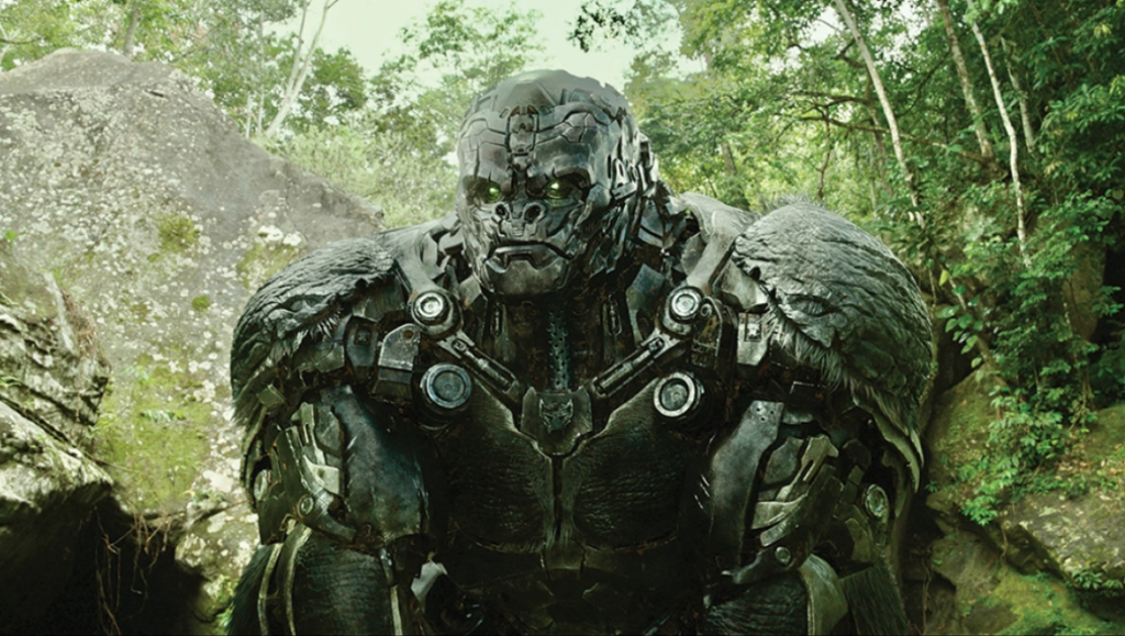 Optimus Primal in Transformers: Rise of the Beasts. Gorilla robot character in jungle setting.