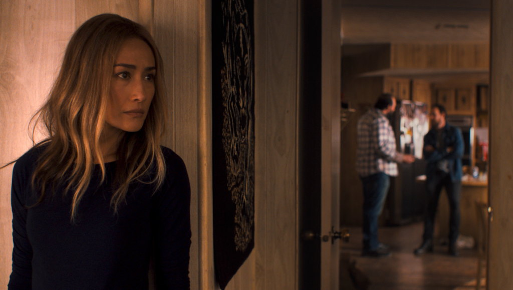 Fear the Night movie scene: Woman looking worried, two men in background. Thriller film.