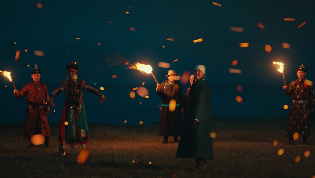 The Cord of Life film still from NY Asian Film Festival 2023. People in traditional Mongolian clothing hold torches.
