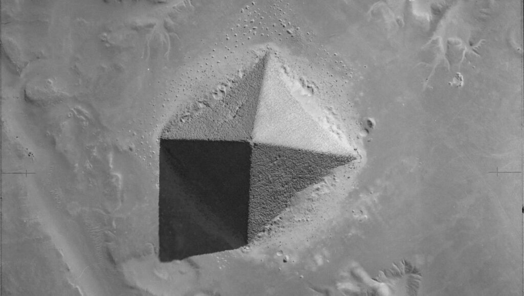 Monochrome aerial view of a pyramidal rock formation on Mars. Martian landscape.