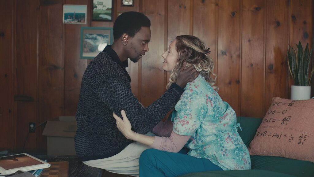 Aporia — Jared Moshé Still from Aporia, Fantasia Fest 2023. A man and woman embrace. The woman wears a floral top and the man a dark sweater.