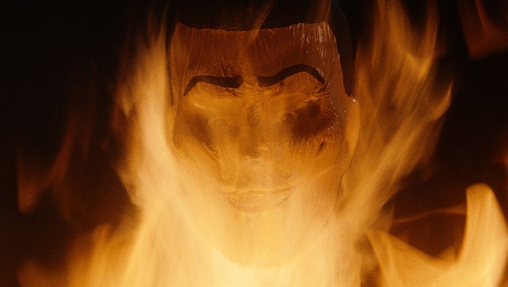 Don’t Look Away — Michael Bafaro Still from Don't Look Away by Michael Bafaro: A face engulfed in flames. Horror film.