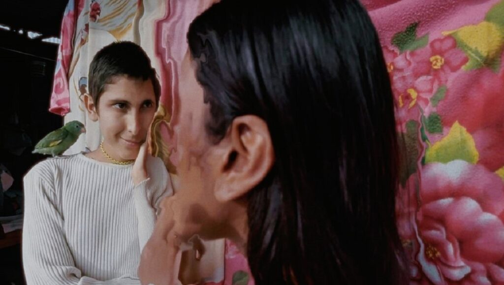 The Human Surge 3 film still from Locarno Film Festival. Woman with bird on shoulder.