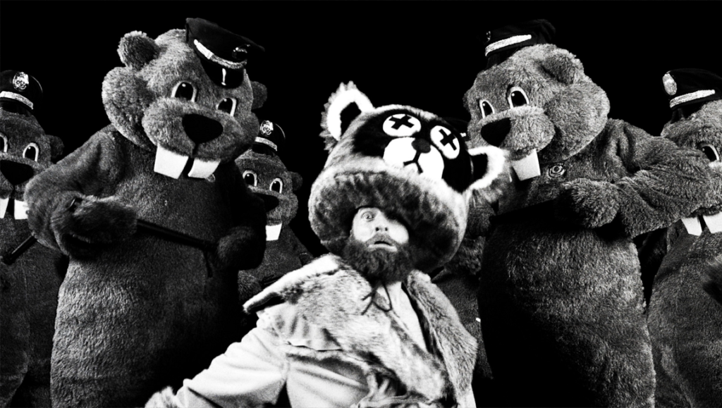 Hundreds of Beavers film still. Black and white image of a man surrounded by people in beaver costumes. Fantasia Fest 2023.