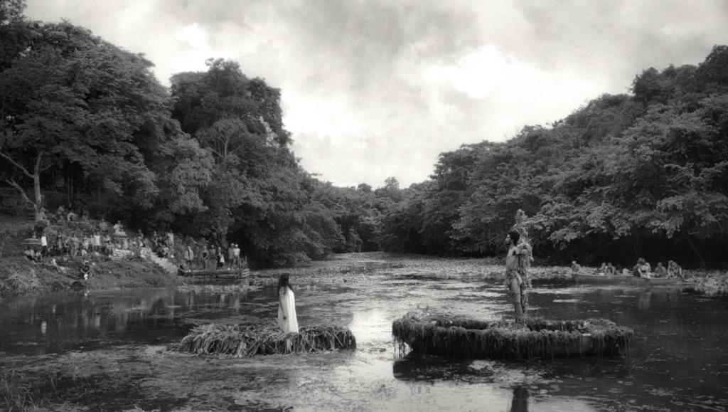 Gli oceani sono i veri continenti performance art at Venice Film Festival 2023. Black and white image of figures in water.