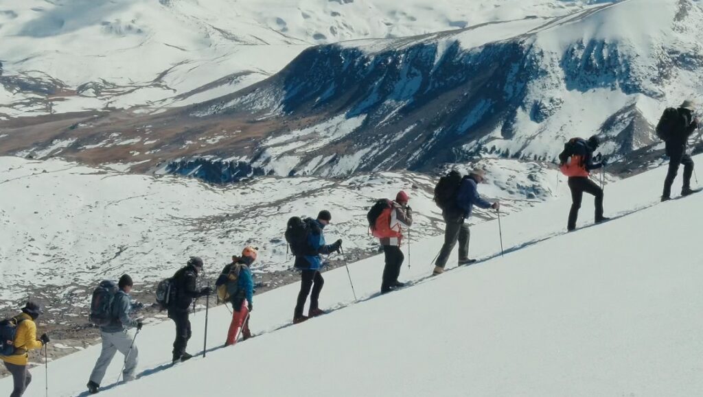 Canary — Danny O’Malley & Alex Rivest Hikers trek up a snowy mountain in Canary by Danny O'Malley & Alex Rivest. Mountaineering adventure.