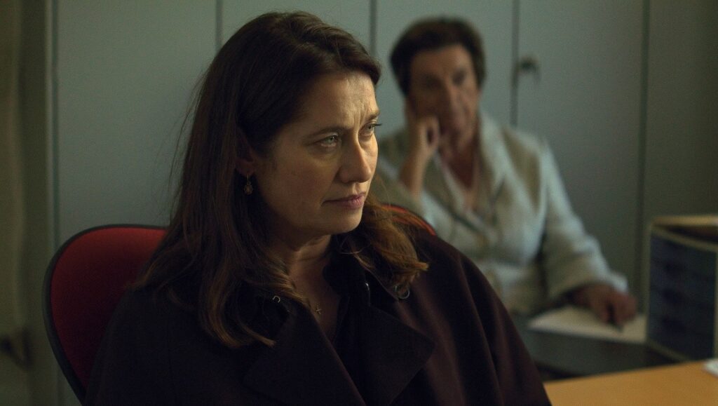 Joachim Lafosse's The Silence film still. Woman in foreground, man blurred in background. SSIFF '23 Review.