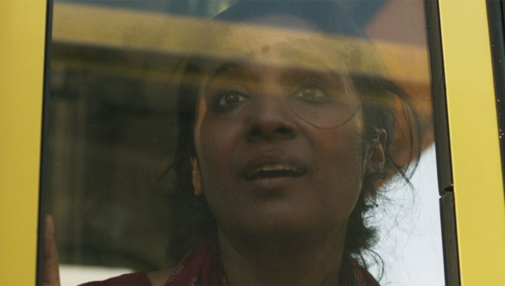 TIFF 2023: Woman in He Thought He Died on a yellow bus. Toronto International Film Festival movie still.