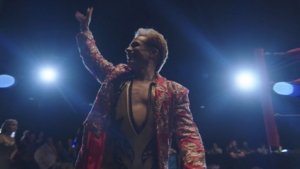 Cassandro — Roger Ross Williams Gael Garcia Bernal as Cassandro, the groundbreaking luchador, waves to the crowd in the Amazon Prime Video film.