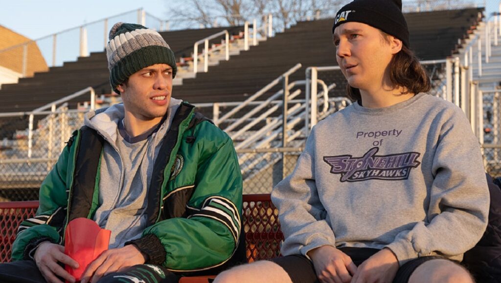 Pete Davidson and Paul Dano in Dumb Money at TIFF 2023. Movie scene with actors in casual clothing.