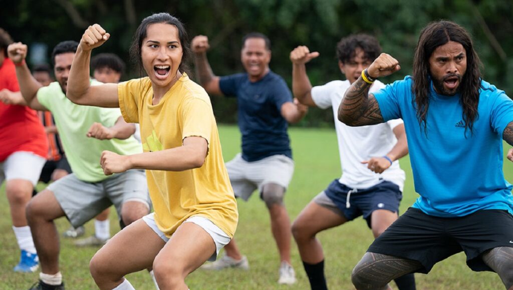 Next Goal Wins film scene. Cast doing a haka, a traditional Māori dance. Taika Waititi film.
