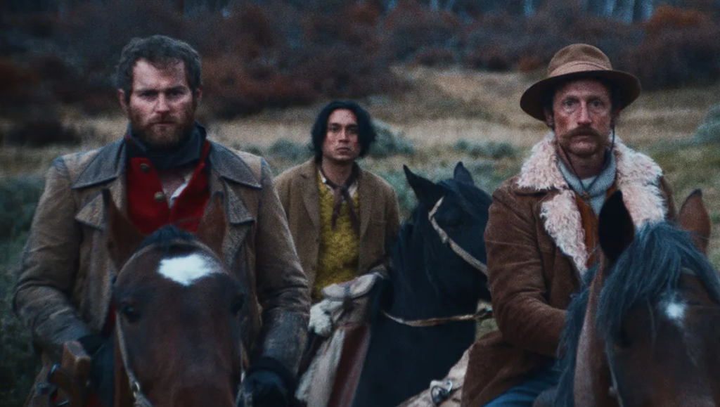 The Settlers movie scene. Three men on horseback in period clothing. Western film review.