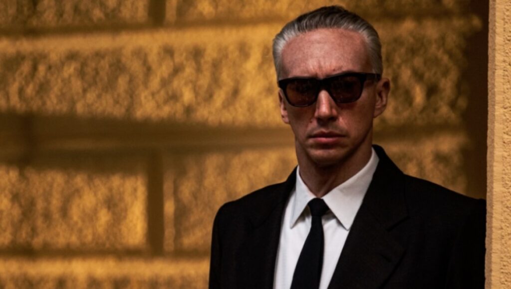 Adam Driver as Enzo Ferrari in Ferrari, directed by Michael Mann.