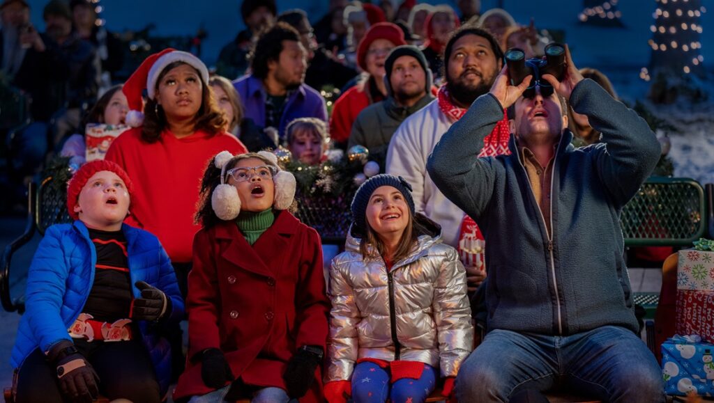 Best Christmas Ever! Family watches a parade, man uses binoculars. Holiday cheer and excitement.
