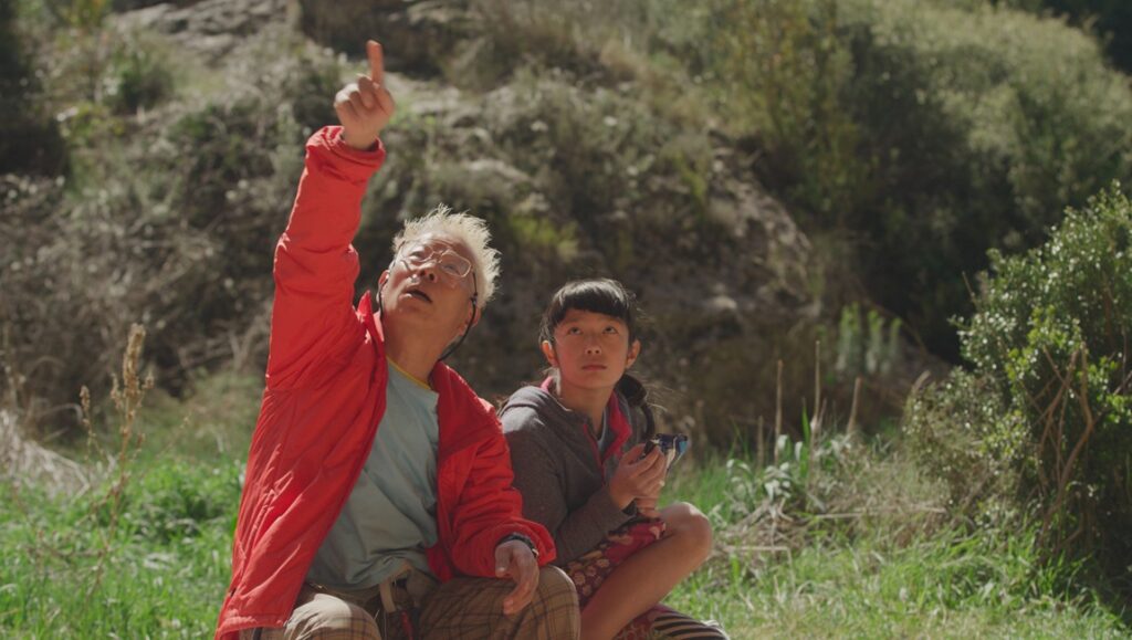 They Shot the Piano Player film still. Man points up as a child looks on in this Fernando Trueba & Javier Mariscal movie.