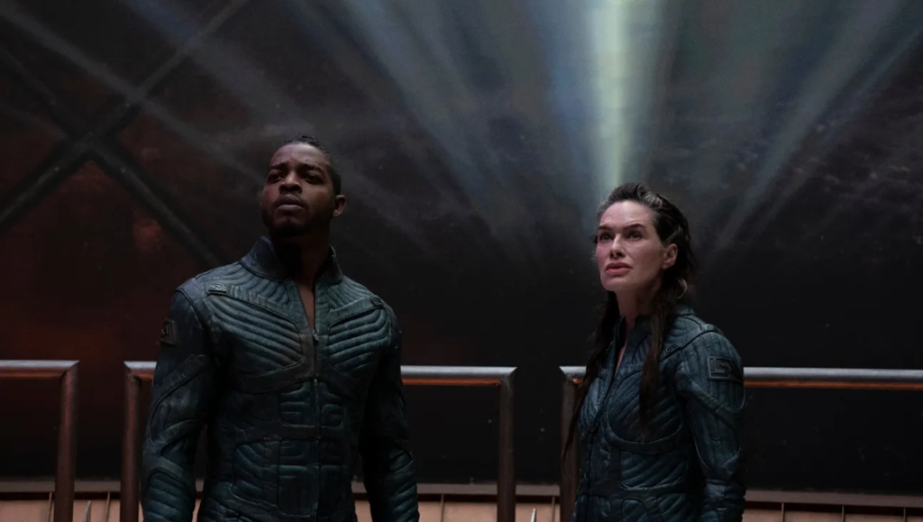 Beacon 23 stars Lena Headey and Stephan James in a sci-fi scene, looking upwards.