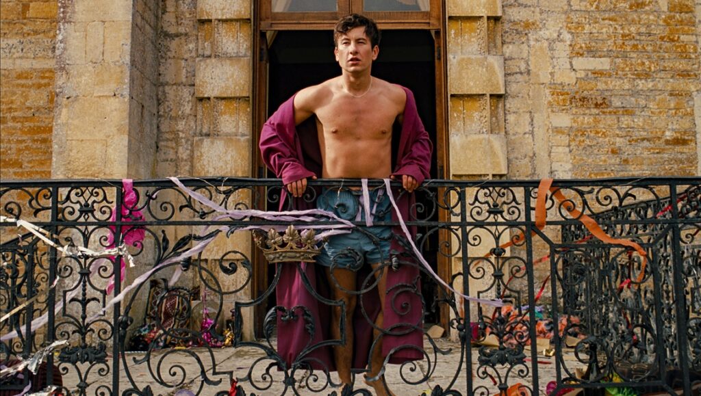 Barry Keoghan in Saltburn. Shirtless on a balcony with robe. Emerald Fennell film.