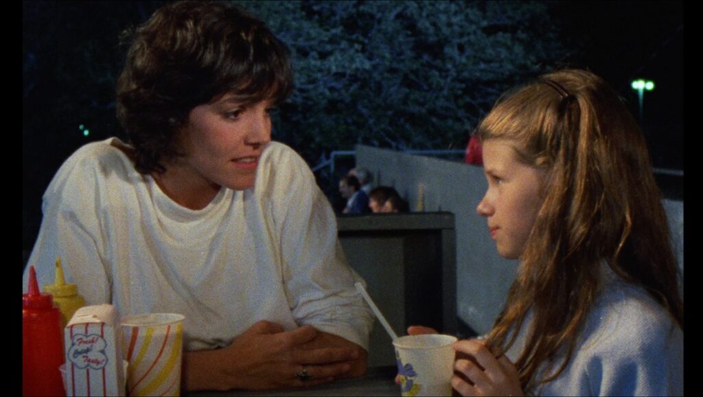 Vengeance is Mine film scene: Woman and girl at a table with condiments and snack cups. Michael Roemer movie.