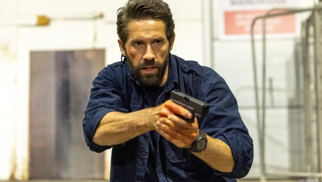 Scott Adkins in One More Shot movie review. Action scene with a gun.