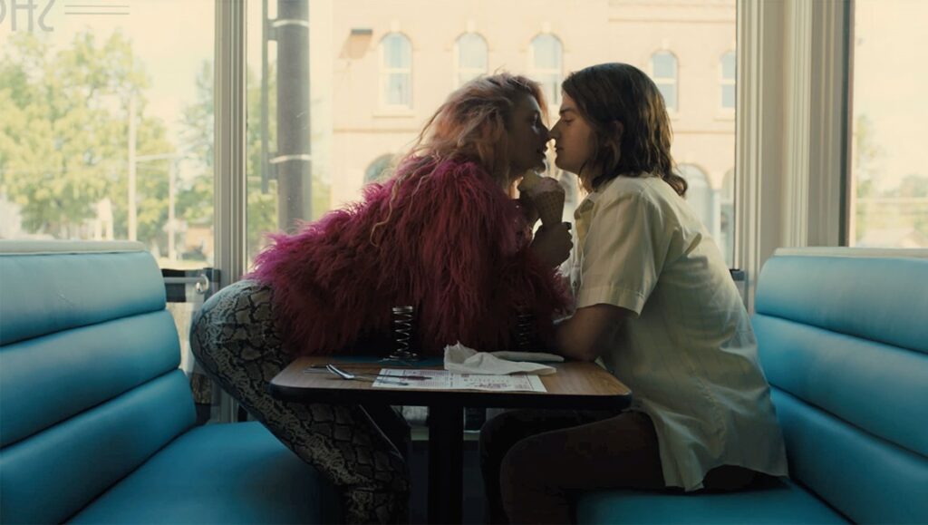 Marmalade movie scene: Two lovers embrace in a diner booth. Romantic, quirky film still.