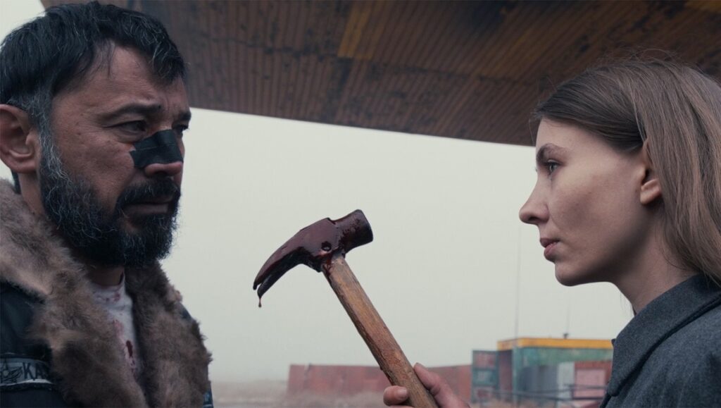 Borrowed Time film still: Man with face paint, bloody hammer, and woman. IFFR '24 review.