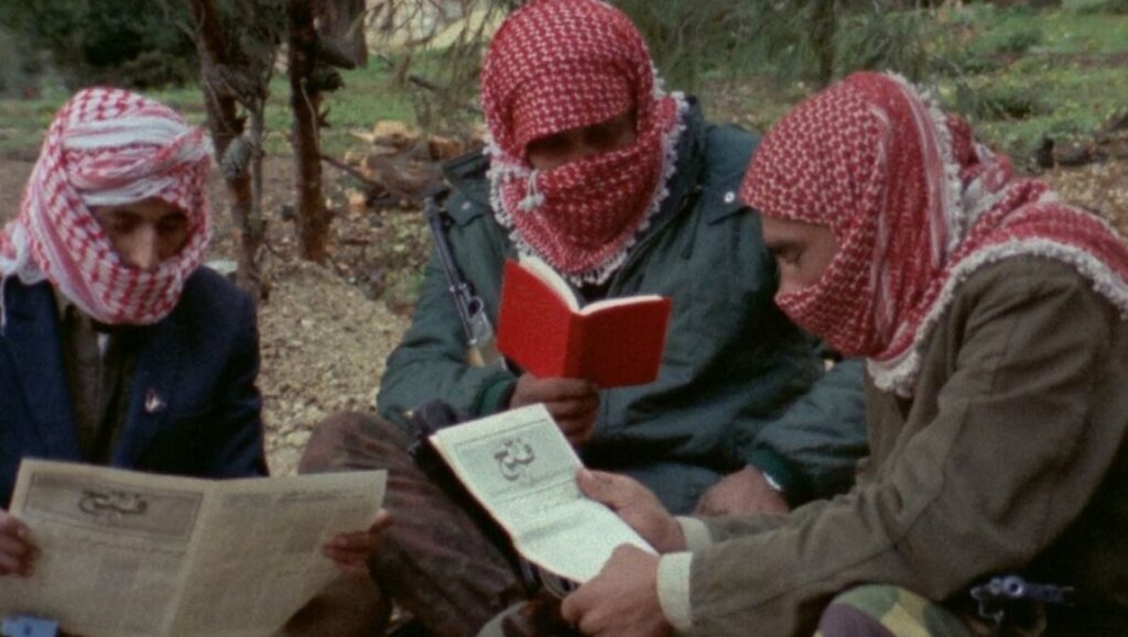 Three men in keffiyehs read books and newspapers in Here and Elsewhere by Jean-Luc Godard and Anne-Marie Miéville.