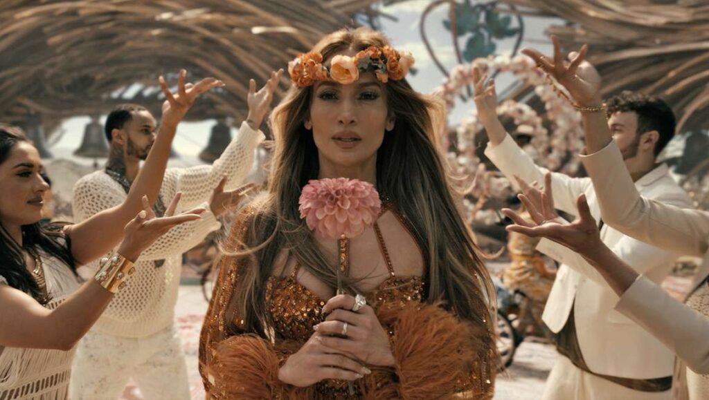 This Is Me… Now: A Love Story — Dave Meyers Jennifer Lopez in This Is Me... Now: A Love Story. JLo wears a flower crown and holds a pink flower.