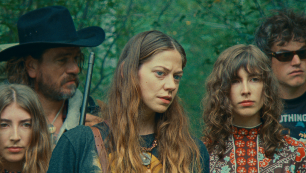 Riddle of Fire movie cast. Weston Razooli film review. Group of young adults in a forest setting.