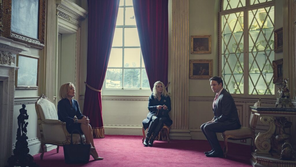 Scoop film scene: Gillian Anderson, Billie Piper, and Rufus Sewell sit in an ornate room.