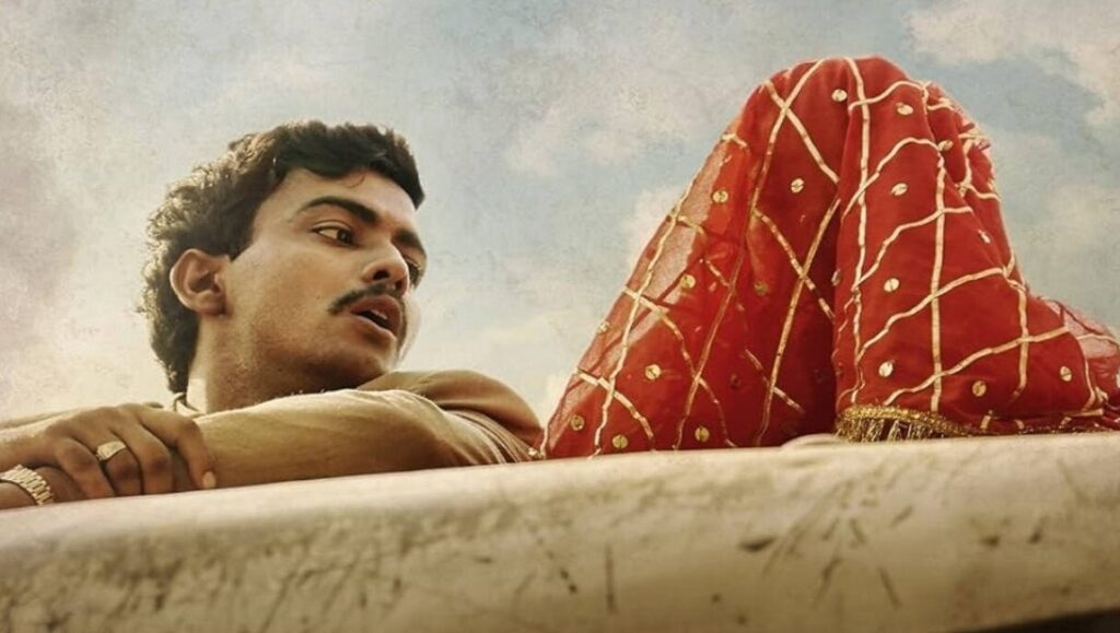 Lost Ladies movie image. Man looks at a woman covered with a red veil. Kiran Rao film.