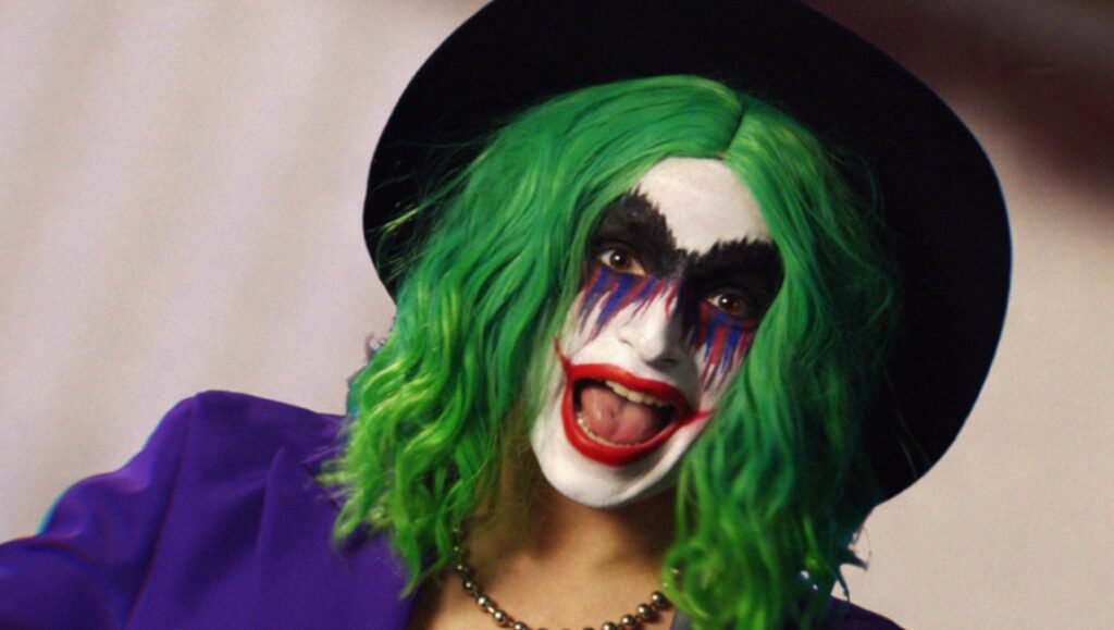 Real Magic in That Kind of Art: An Interview with Vera Drew Vera Drew as the Joker. Green hair, purple suit, and Joker makeup. Real Magic in That Kind of Art.