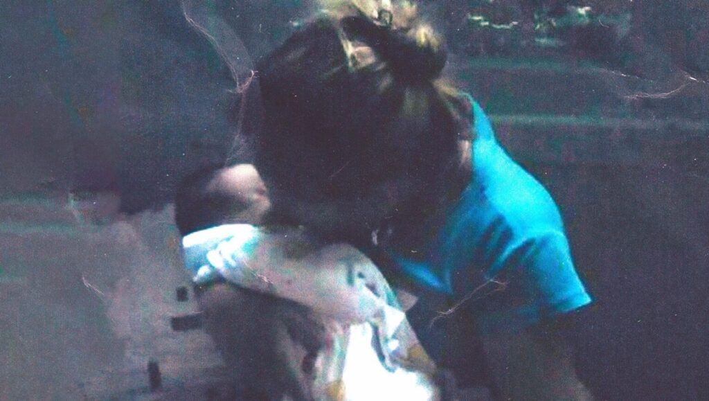 Still from Malqueridas: Tana Gilbert Fernández holds a baby. LAFM '24 review.